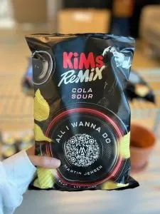 KiMs Remix Cola Sour crisp bag with a QR code linking to the campaign