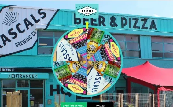 Rascals Brewing wheel of fortune with beer cans in front of the brewery